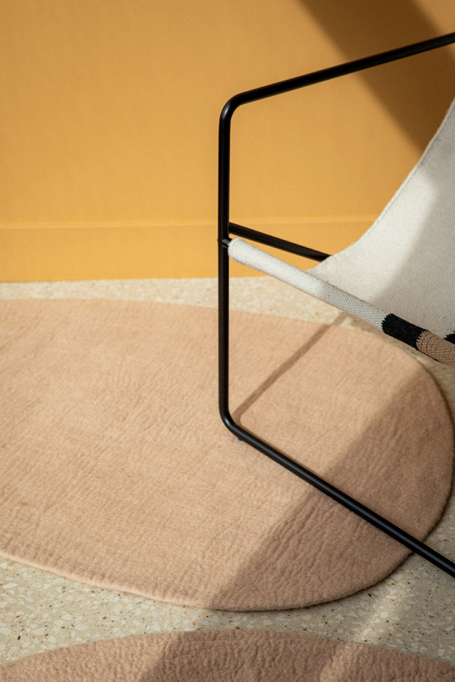 Duo of natural felt pebble rugs on the way to the bathroom