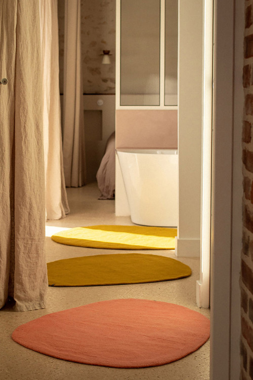 Duo of natural felt pebble rugs on the way to the bathroom Duo of natural felt pebble rugs on the way to the bathroom