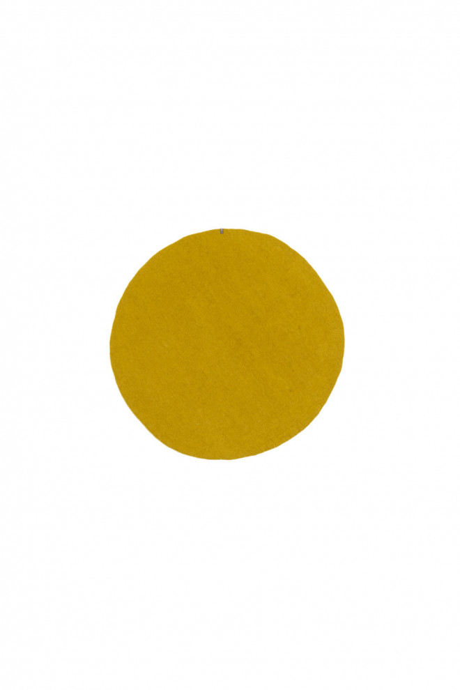 4 small round wool felt rugs in a room