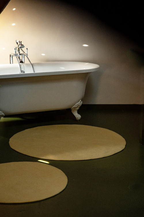 Duo of round bath mats in yellow wool felt