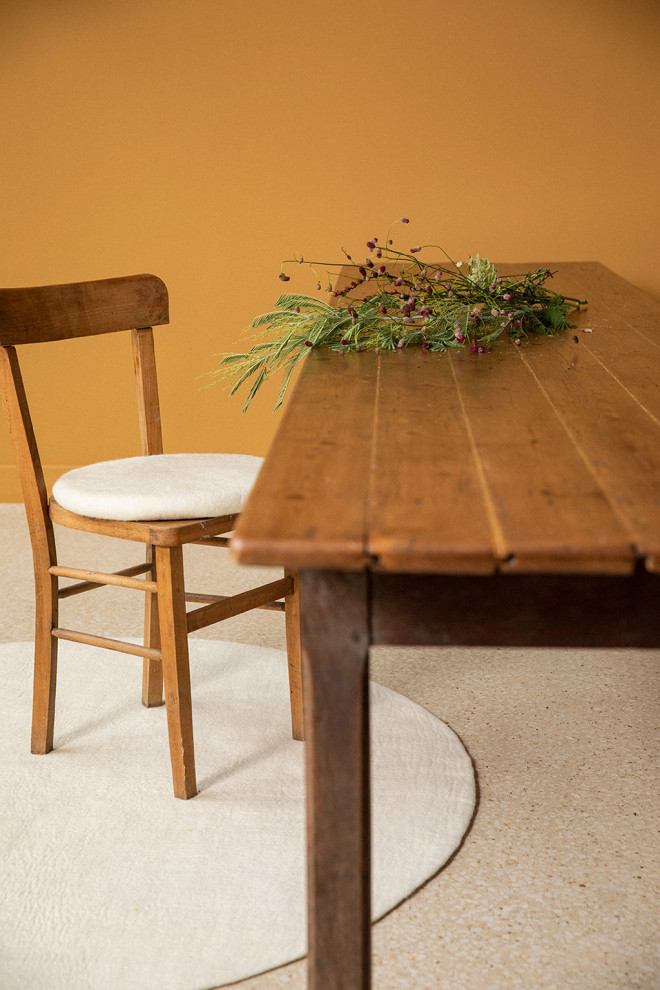 4 small round wool felt rugs in a room