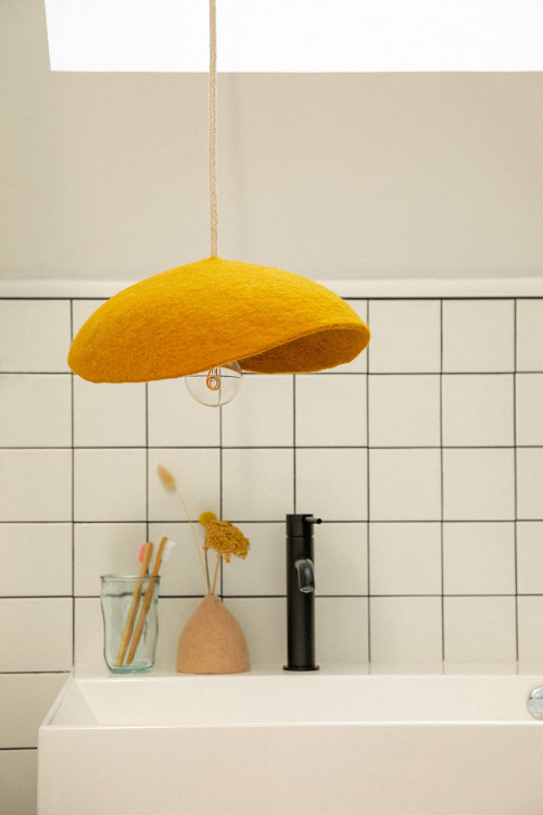 A large rounded wool felt lampshade to light up the bathroom