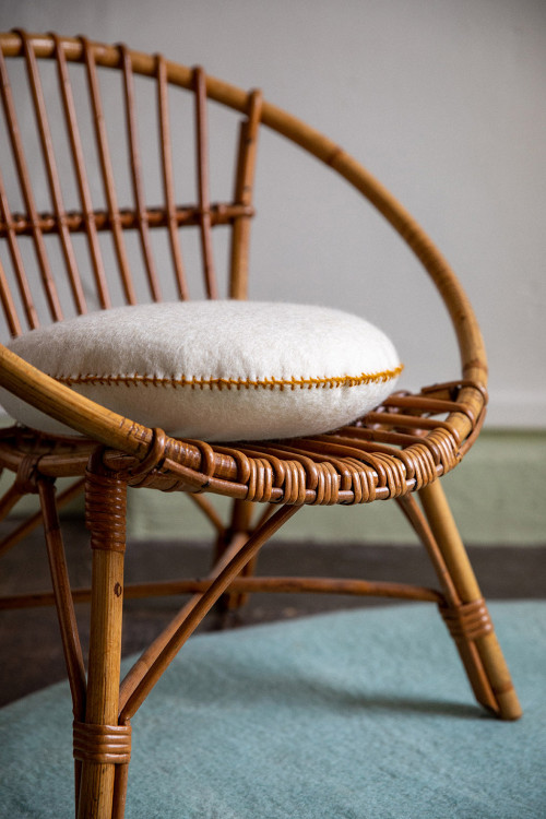 atural felt cushion in a rattan armchair