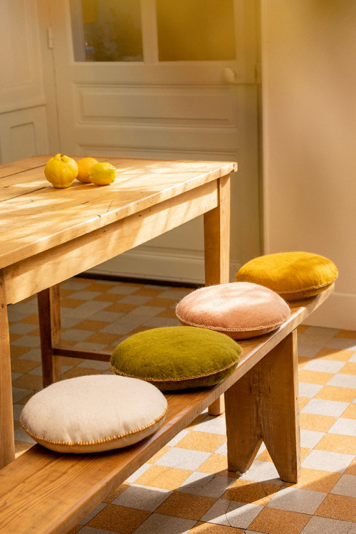 Felt cushions sit on a bench in the dining room
