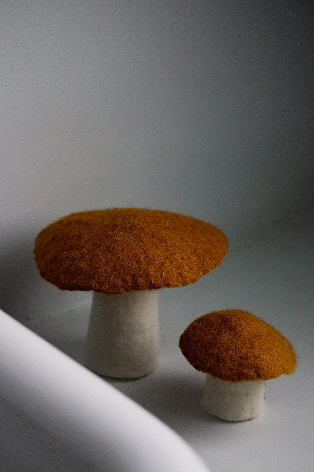 two ochre mushrooms in felt for a playful decoration