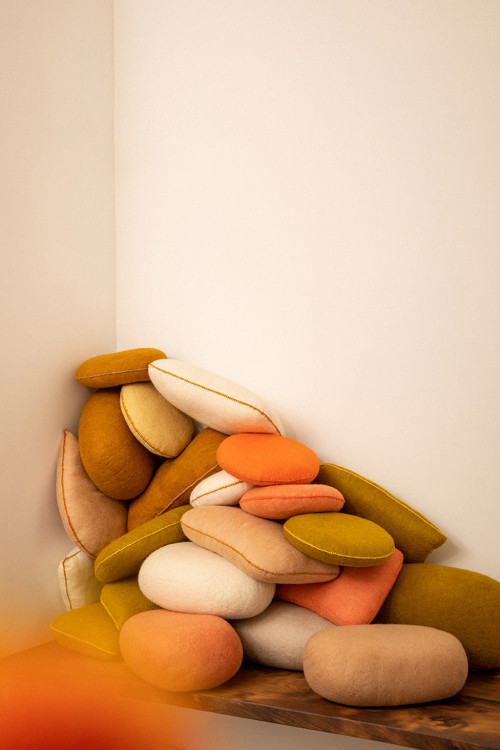 Pile of cushions in the corner of a living room for a playful atmosphere