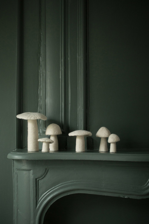 white woolen mushrooms on a mantel for a pure and poetic decoration