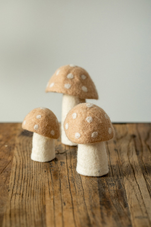 three sizes of polka dot mushrooms made with natural felt