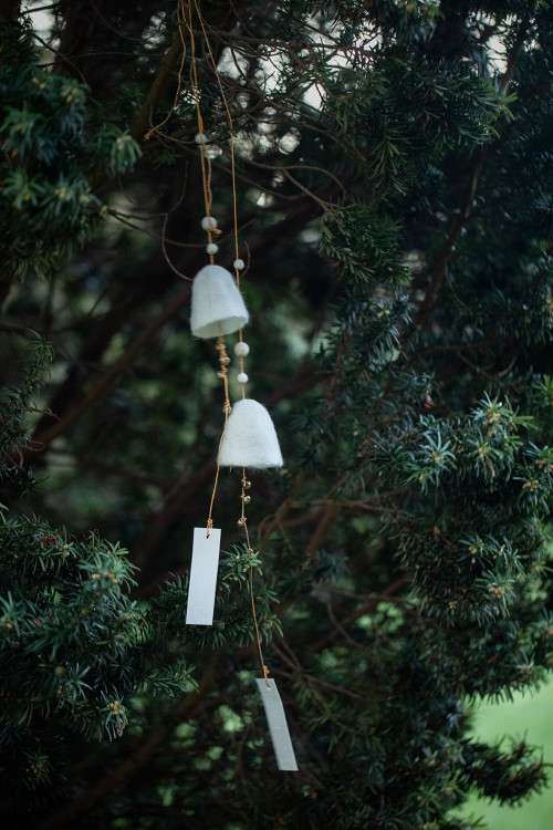 two felted wool bells are carried by the wind in a light way two felted wool bells are carried by the wind in a light way