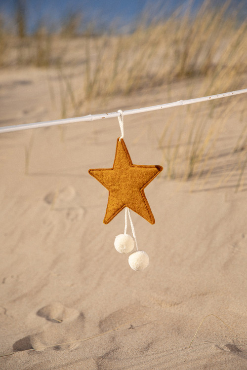 a gold felt star with white pompons for a colorful touch a gold felt star with white pompons for a colorful touch
