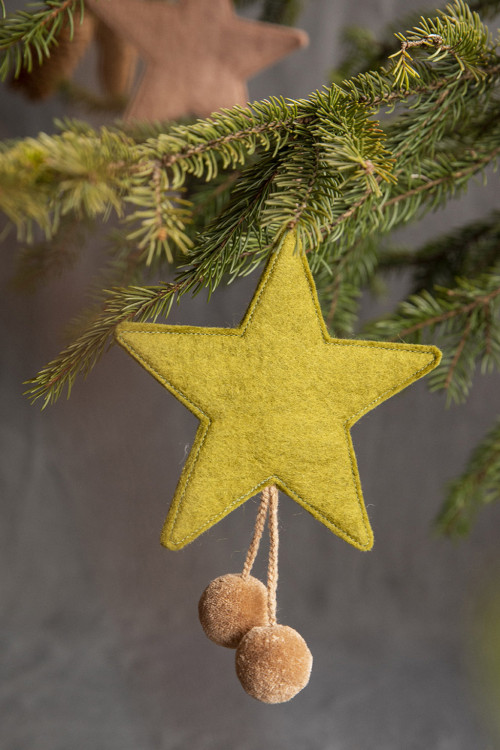 a green wool star with pink pompons for a colorful touch in your home