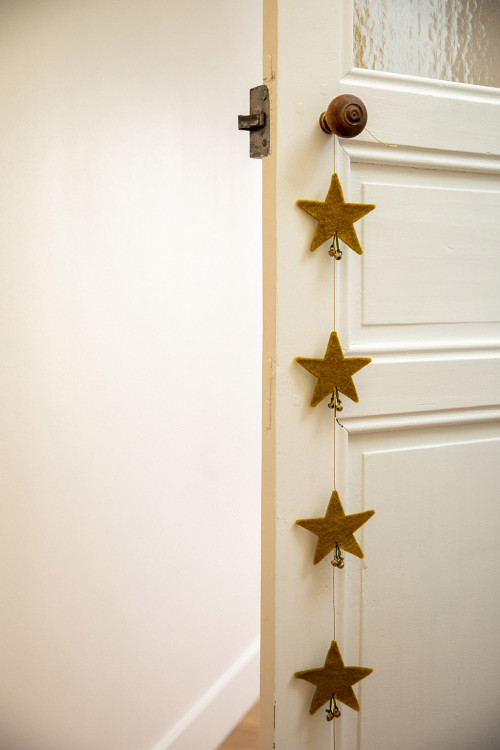 a garland of stars hanging from a door handle for a poetic decoration a garland of stars hanging from a door handle for a poetic decoration
