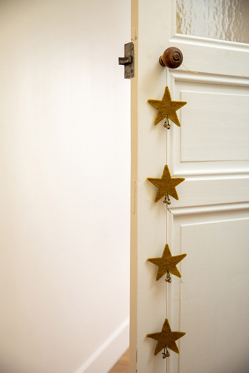 a garland of stars hanging from a door handle for a poetic decoration