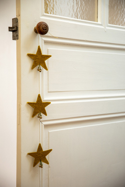 stars form a garland hanging from a door handle for a delicate touch