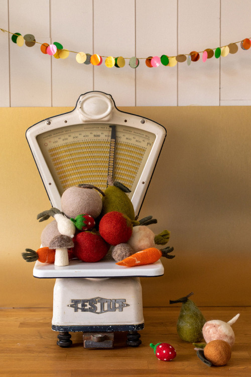 a scale covered with felt fruits and vegetables for a playful decoration
