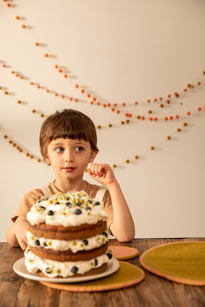 Felt pompons on a golden thread to create a playful garland