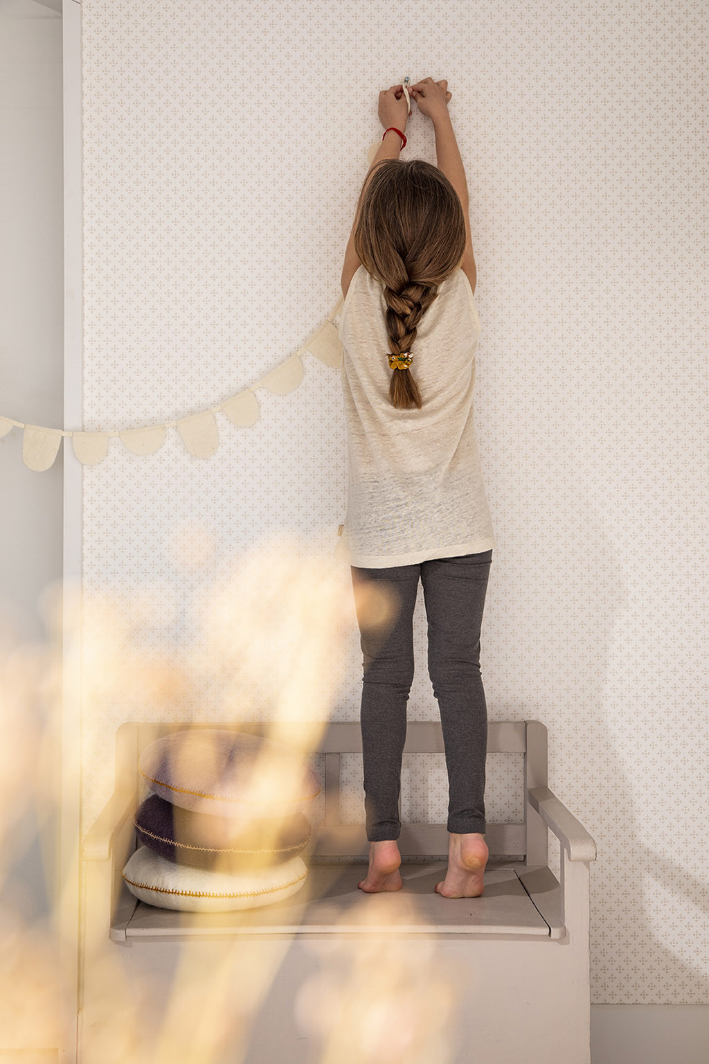 a white felt garland to hang on the wall of a child's room