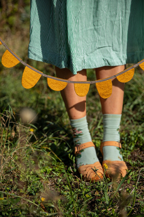 ochre felt garland with strappy sandals