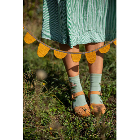 ochre felt garland with strappy sandals