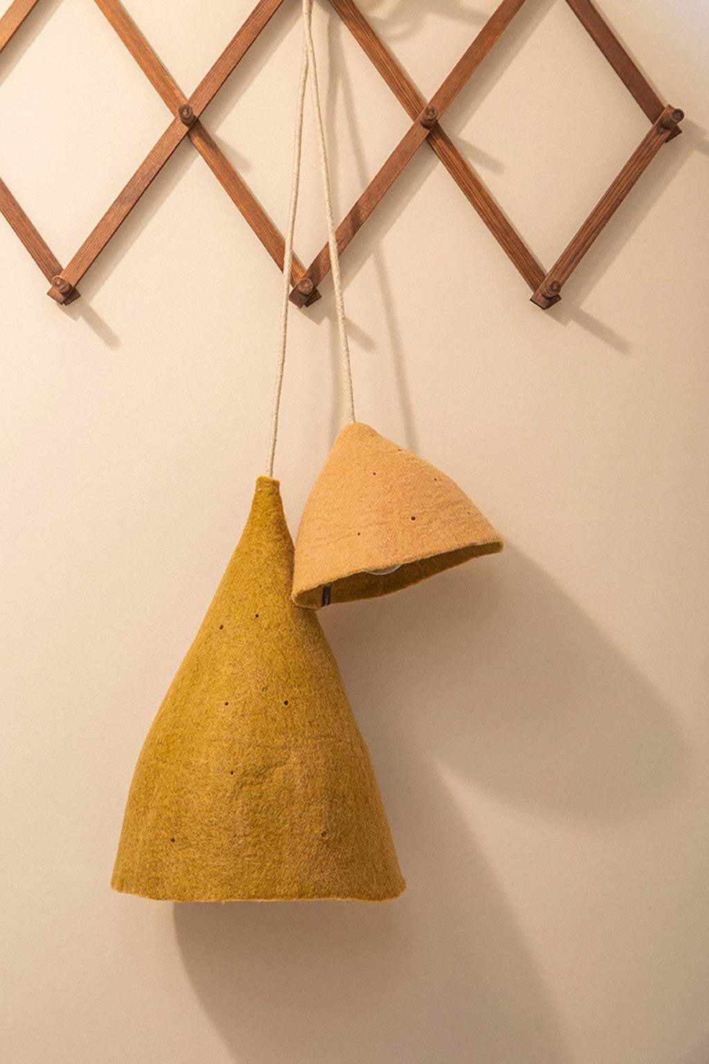 Two felted wool lampshades hanging in the entrance