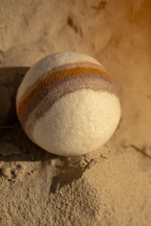 a rainbow designed on a handmade felt ball a rainbow designed on a handmade felt ball