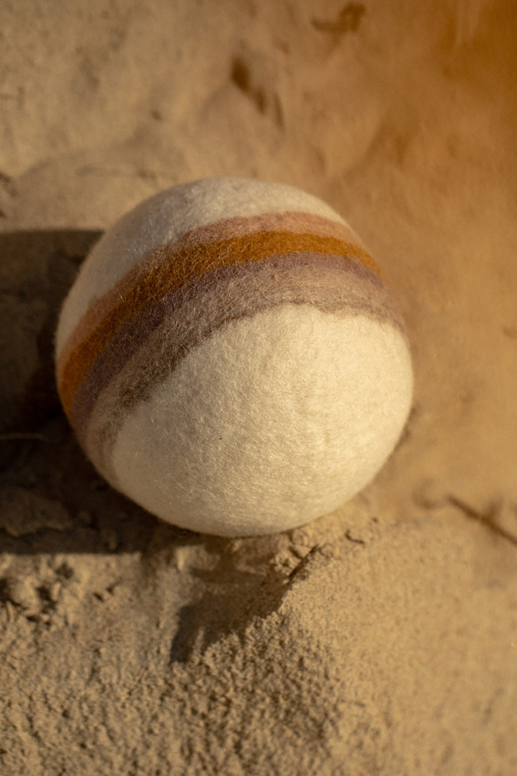 a rainbow designed on a handmade felt ball
