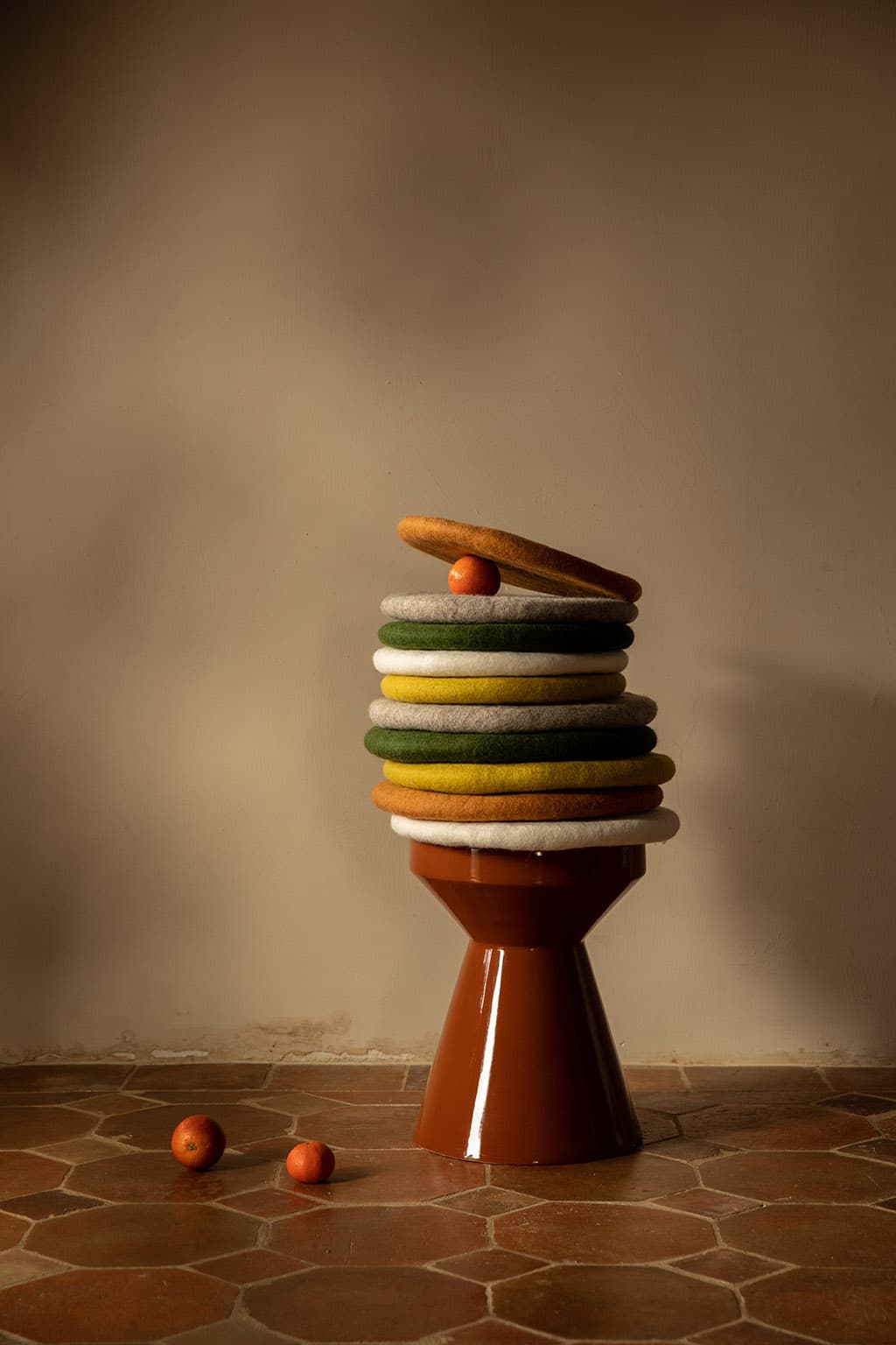 Stack of round wool felt cushions to make chairs and stools more comfortable