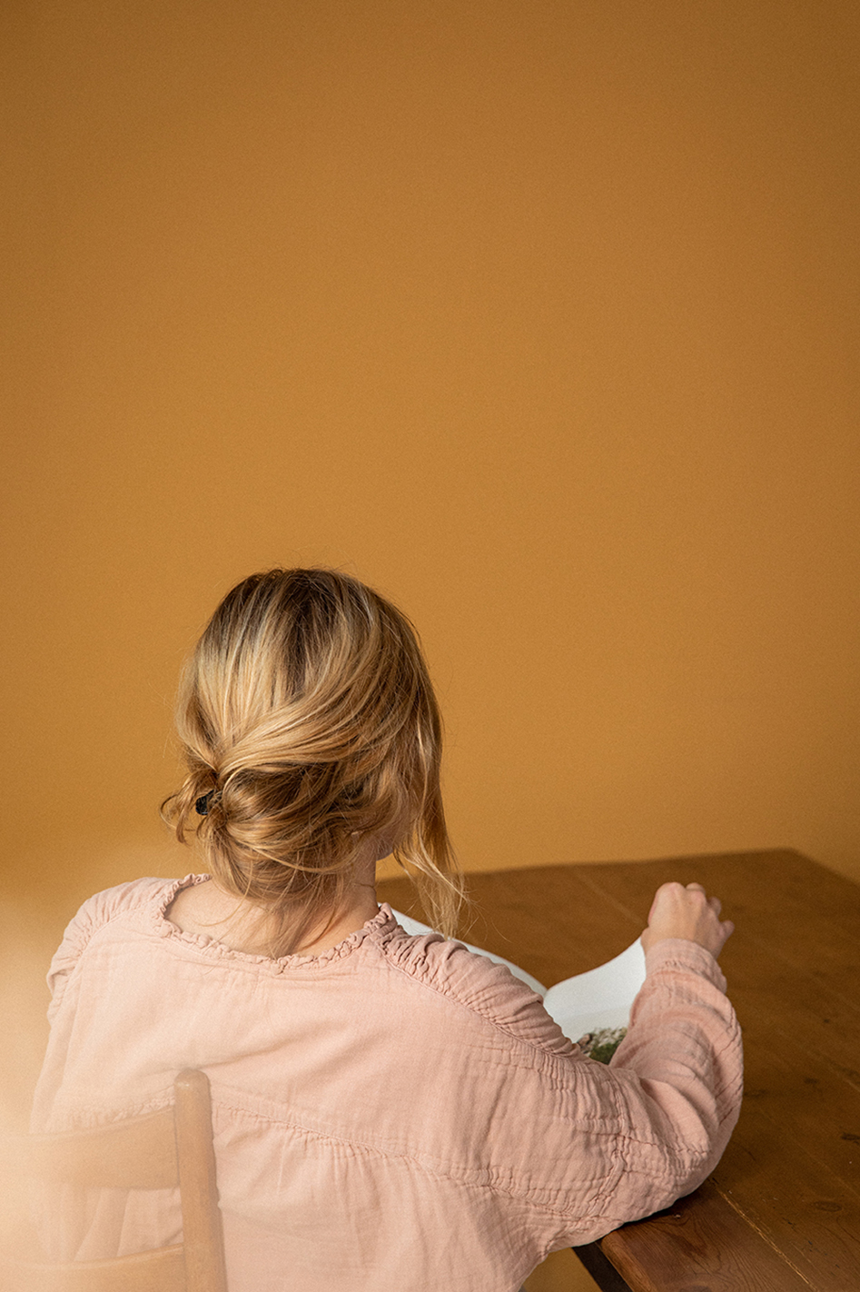 Woman from behind reading a book