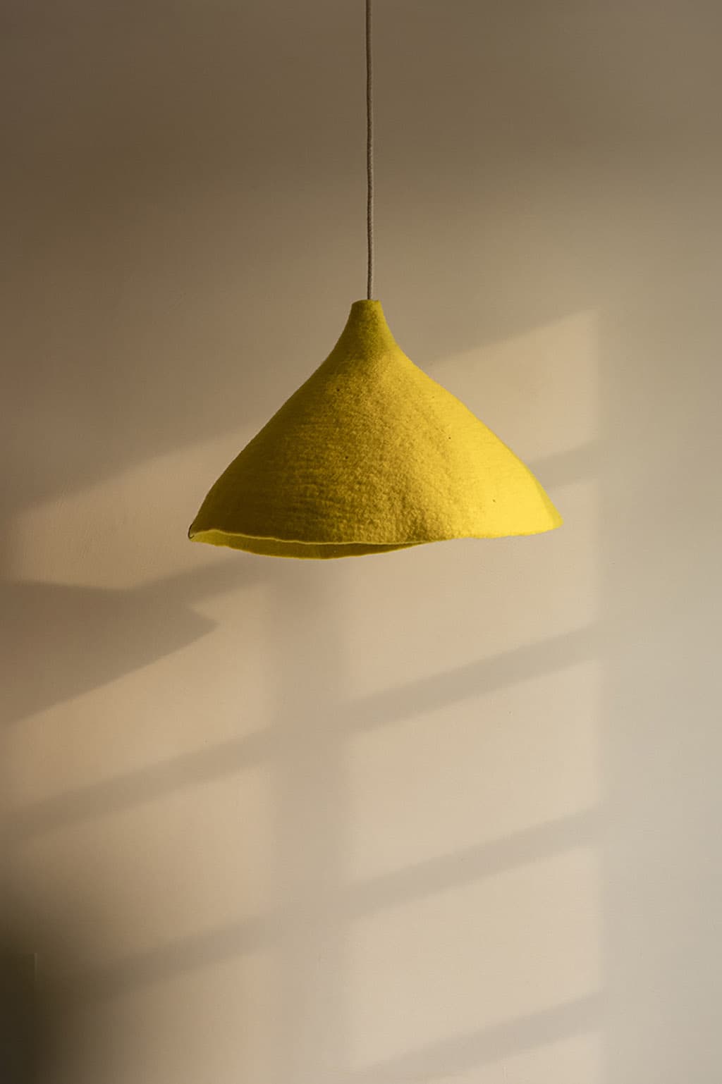 Yellow organic pendant light in felted wool