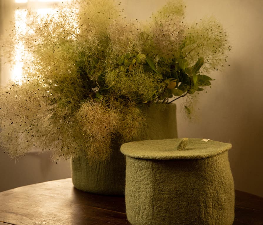 Set of two sage green storage baskets made of wool felt