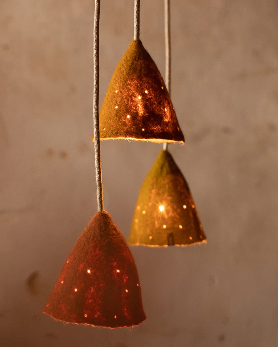 Trio of small perforated red, green and yellow lampshades for delicate lighting