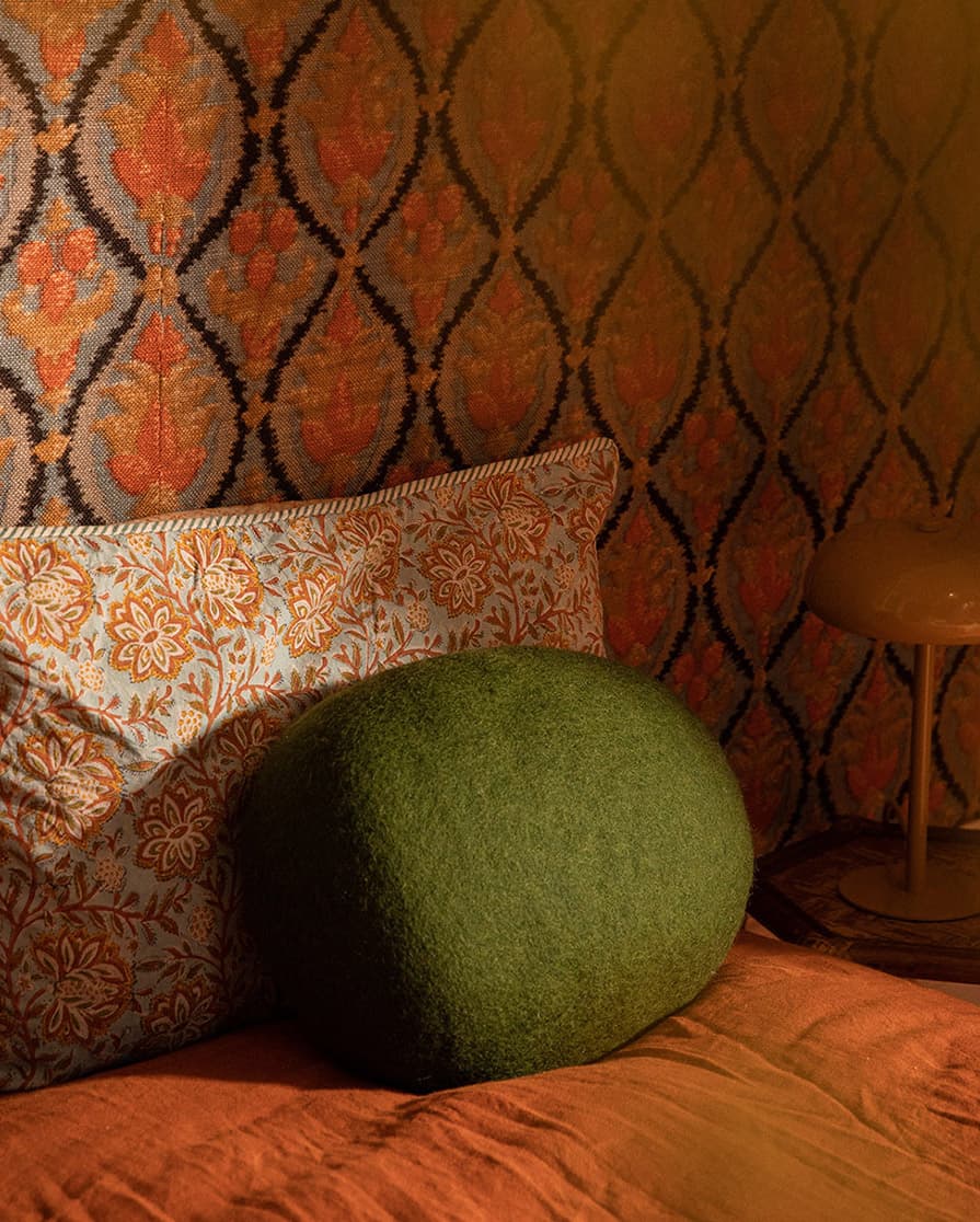 Oval green wool cushion for the bedroom