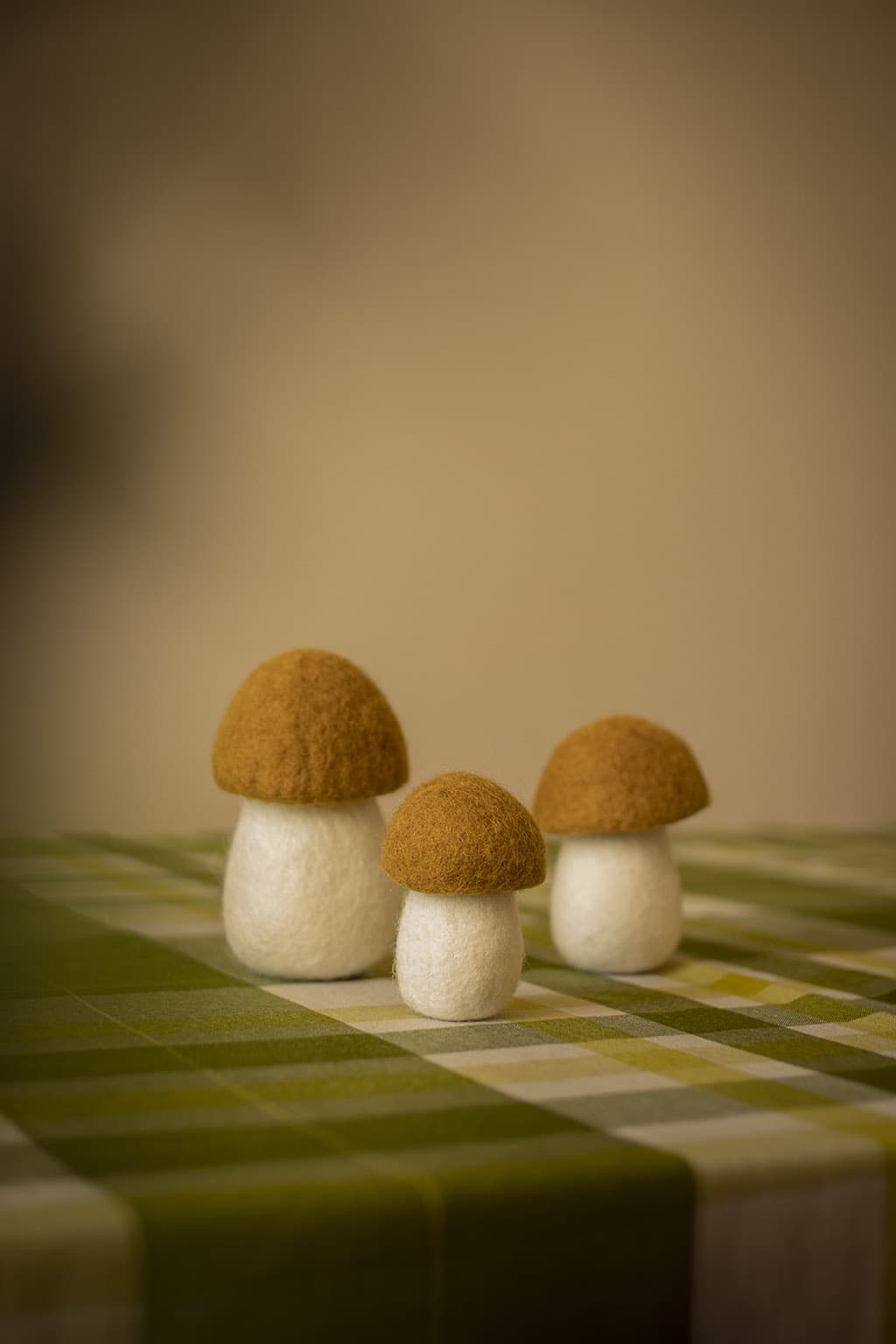 Kleine decoratieve okerkleurige wollen paddenstoelen